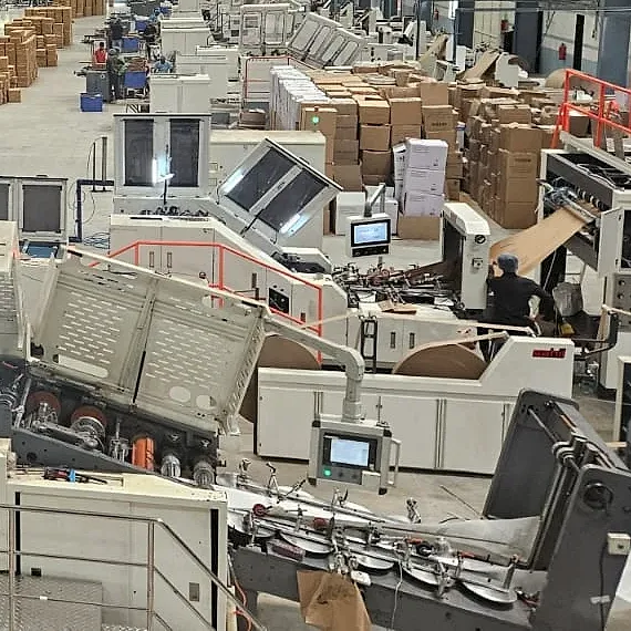 Paper bag making machines running on the J K Industries production floor