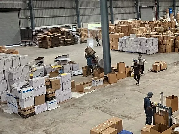 Packed cartons of finished paper bags stacked on the J K Industries factory floor